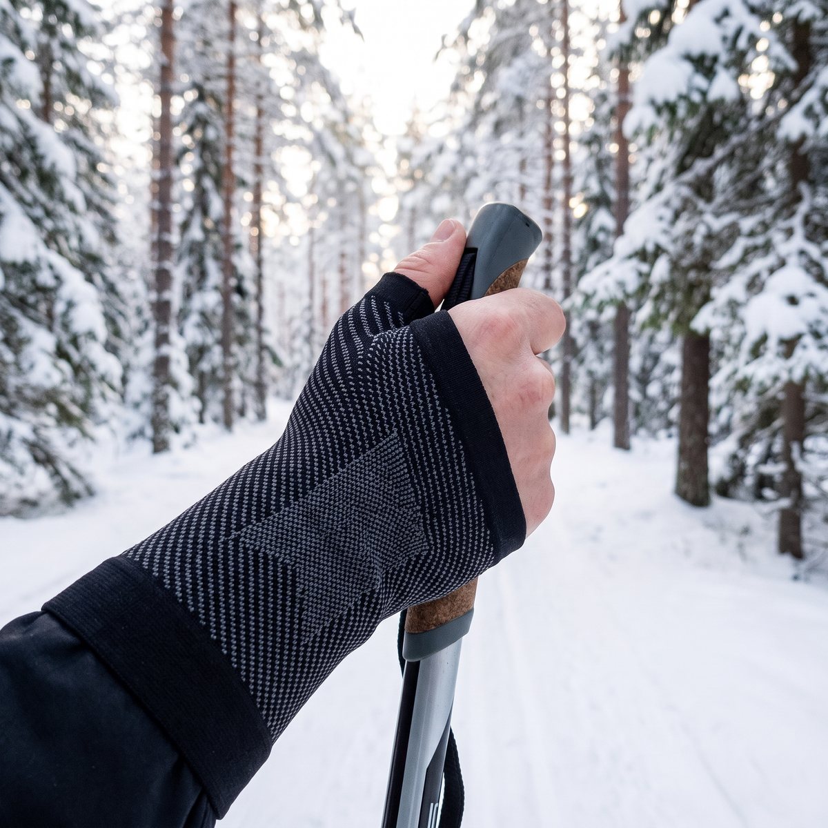 Svart kompressionsstöd med tumöppning vid skidstavsåkning i svensk vinterskog