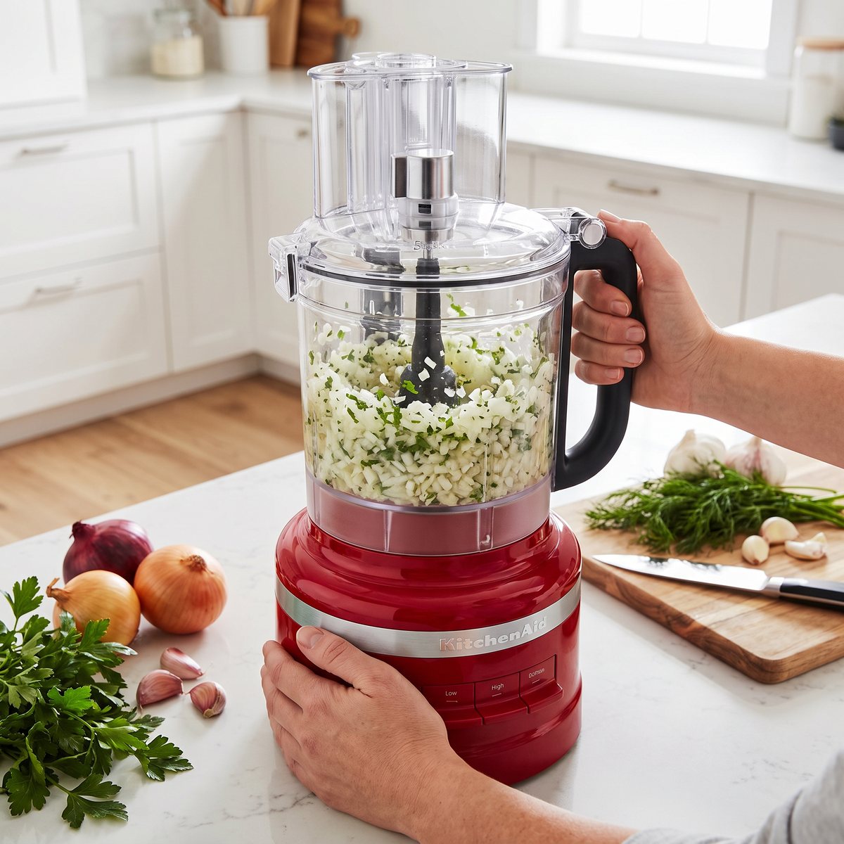 Röd KitchenAid 5KFP1319 matberedare i ett svenskt kök med hackad lök och persilja