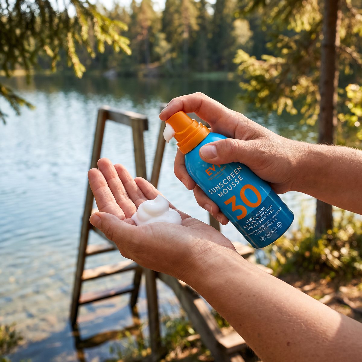 EVY Sunscreen Mousse doseras i handen vid en svensk badplats med bryggstege